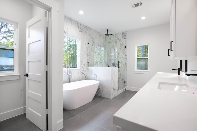 bathroom featuring a healthy amount of sunlight, tile patterned flooring, and shower with separate bathtub