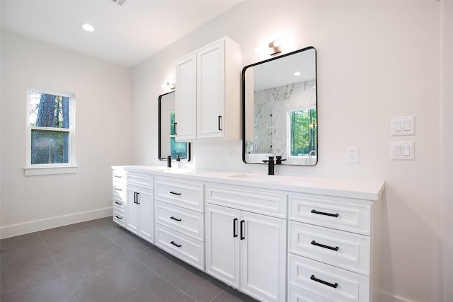 bathroom featuring a shower, vanity, and tile patterned flooring