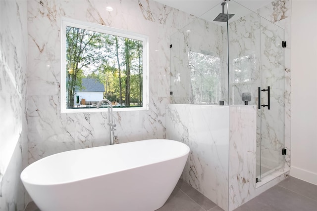 bathroom featuring plenty of natural light, separate shower and tub, and tile patterned flooring