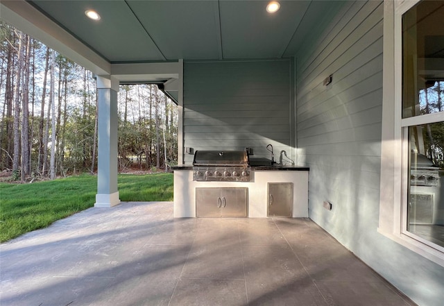 view of patio / terrace with sink, a grill, and area for grilling