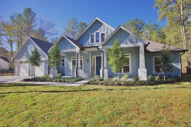 view of front facade with a front yard, a porch, and a garage