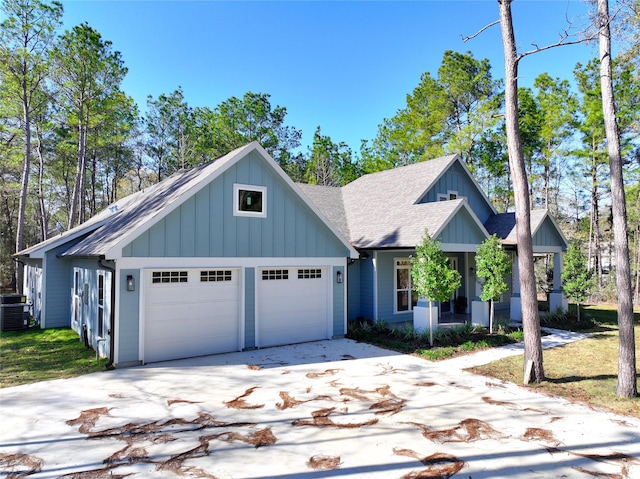 view of front of property with a garage and central AC unit