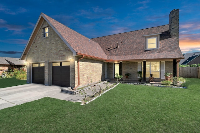 view of front of house with a yard and a garage