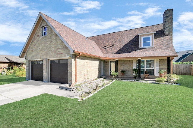 view of front of property featuring a front lawn and a garage