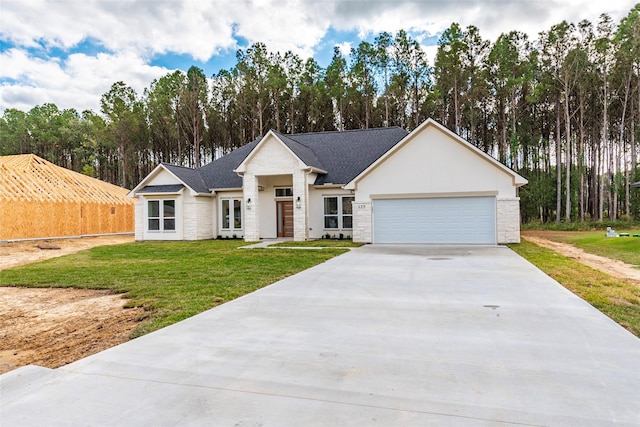 view of front facade with a garage and a front lawn