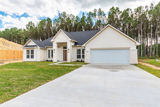 view of front facade featuring driveway, stone siding, roof with shingles, a front yard, and a garage