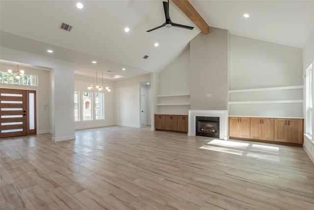 unfurnished living room featuring beam ceiling, high vaulted ceiling, ceiling fan with notable chandelier, and light wood-type flooring