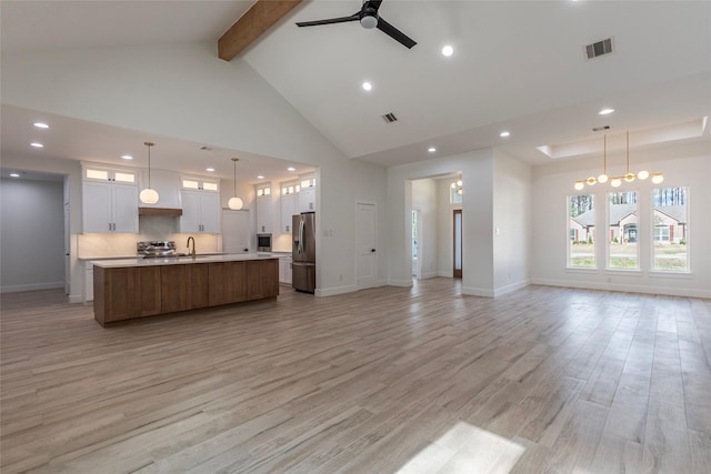 unfurnished living room with beam ceiling, ceiling fan, sink, light hardwood / wood-style flooring, and high vaulted ceiling