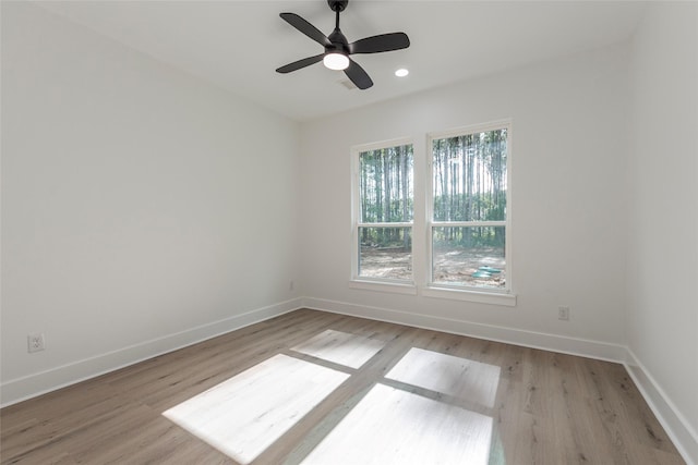 spare room featuring light wood-type flooring and ceiling fan