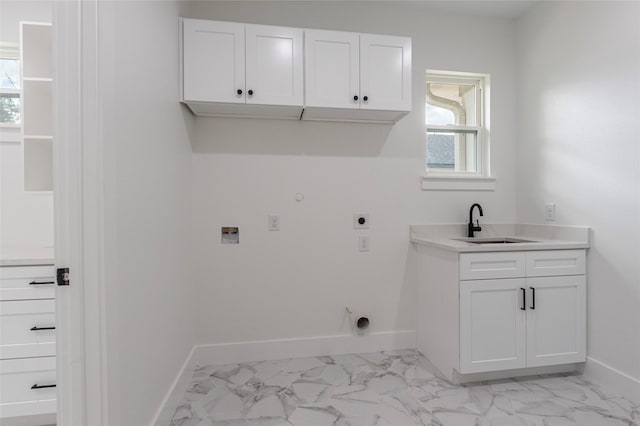 washroom with cabinets, hookup for a gas dryer, electric dryer hookup, and sink