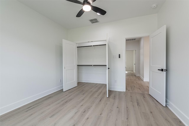 unfurnished bedroom with ceiling fan, light wood-type flooring, and a closet