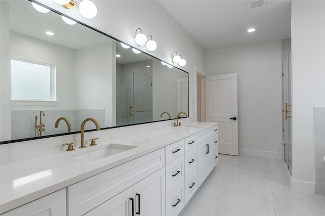 bathroom with vanity and a shower with door