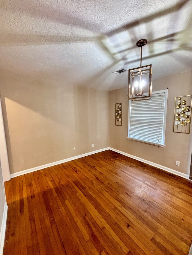 interior space featuring hardwood / wood-style floors and a textured ceiling