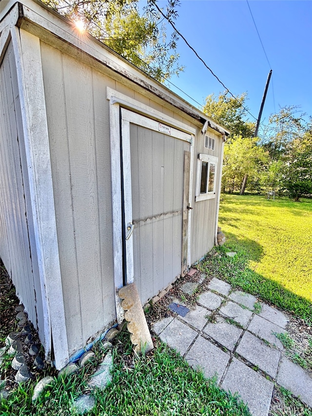 view of outdoor structure with a lawn