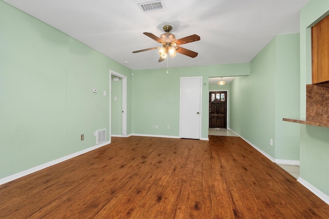 unfurnished living room featuring ceiling fan and light wood-type flooring