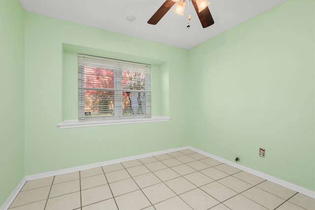 tiled spare room featuring ceiling fan