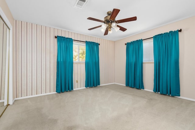 unfurnished room featuring carpet flooring and ceiling fan