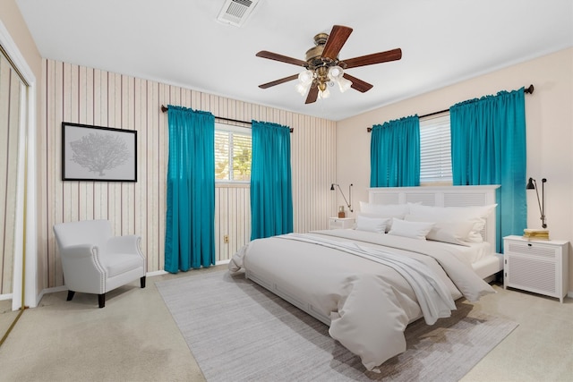 bedroom featuring ceiling fan and light carpet