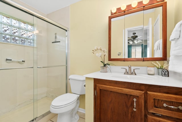 bathroom featuring tile patterned floors, walk in shower, vanity, ceiling fan, and toilet