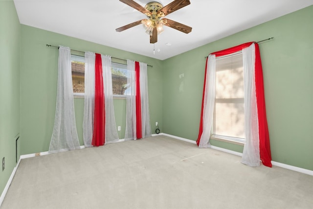 empty room featuring light carpet and ceiling fan