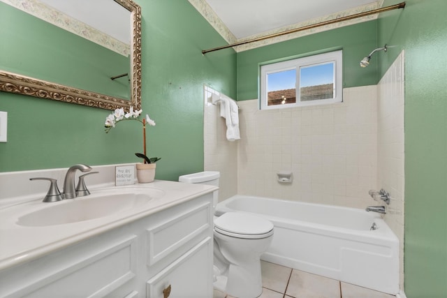 full bathroom featuring tile patterned flooring, vanity, toilet, and tiled shower / bath