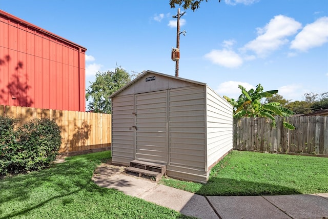 view of outbuilding with a lawn