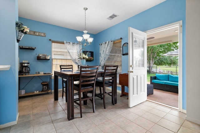 dining room featuring a notable chandelier and light tile patterned flooring