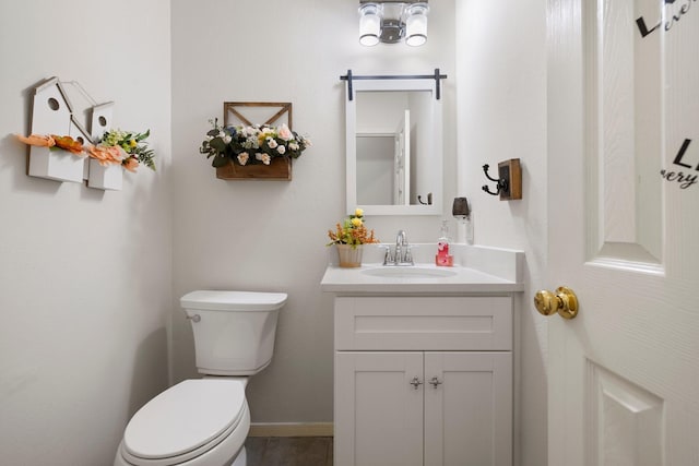 bathroom featuring vanity and toilet