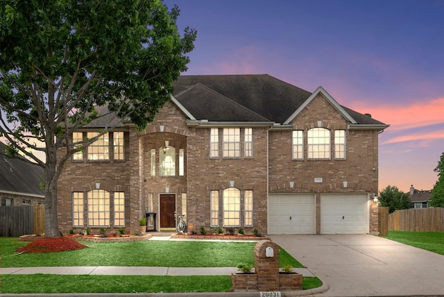 view of front of property featuring a yard and a garage