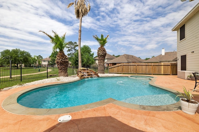 view of pool with a yard, a patio, and pool water feature