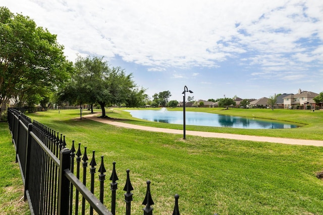 view of home's community featuring a yard and a water view