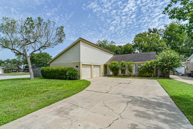 view of front of property featuring concrete driveway, brick siding, and a front yard