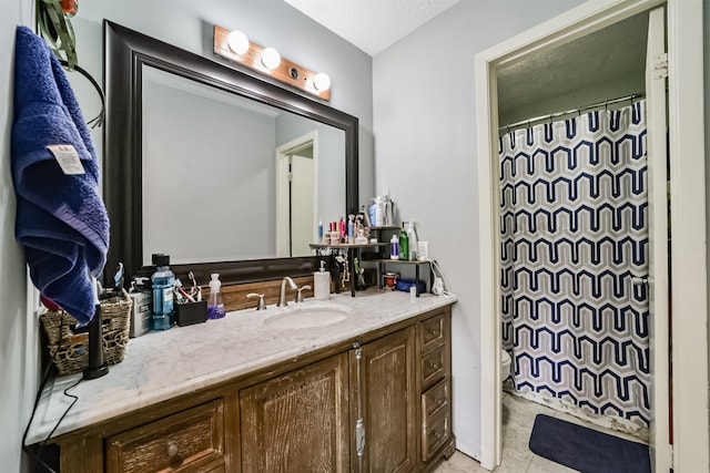 bathroom featuring vanity, toilet, and walk in shower