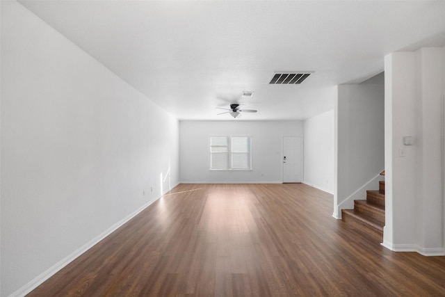 unfurnished living room with ceiling fan and dark wood-type flooring