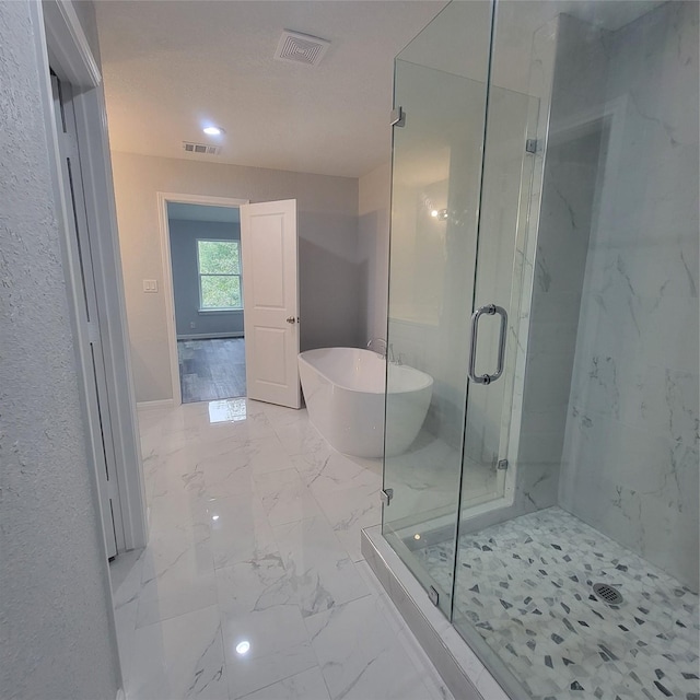 6232 Nuben St, Houston, TX 77091 - full bathroom with marble finish flooring, a freestanding tub, and a marble finish shower