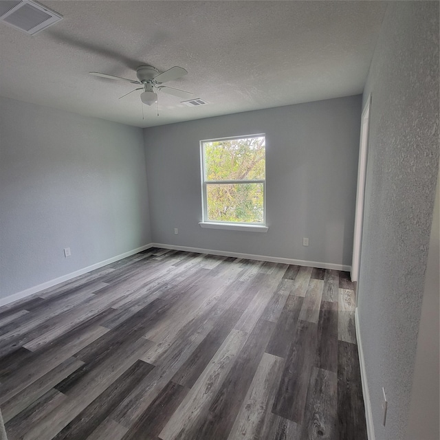 unfurnished room with a textured ceiling, dark hardwood / wood-style flooring, and ceiling fan