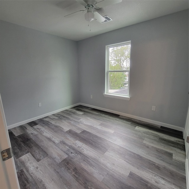 empty room with ceiling fan and light hardwood / wood-style flooring