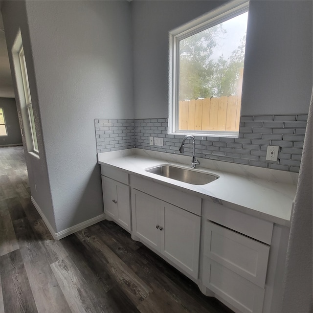 kitchen with white cabinets, tasteful backsplash, dark wood-type flooring, and sink