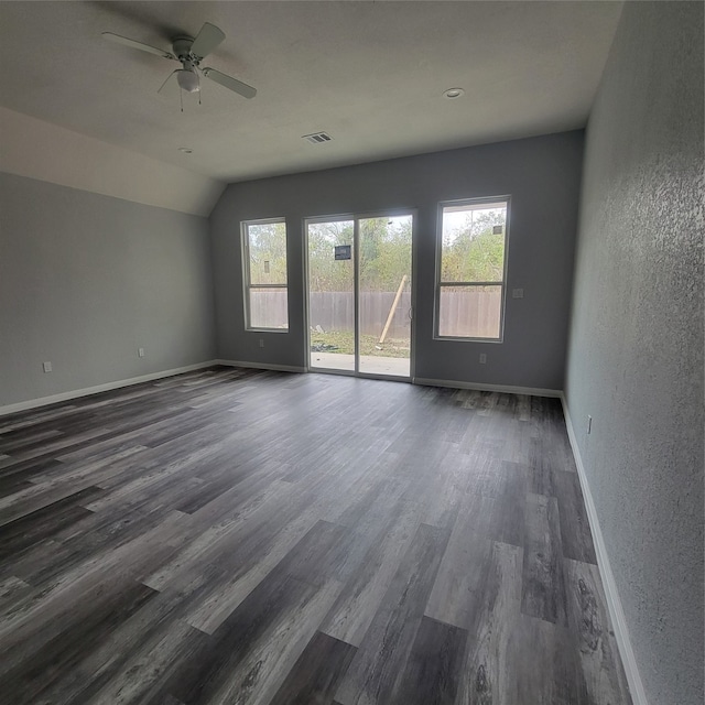 unfurnished room featuring ceiling fan, lofted ceiling, and dark wood-type flooring