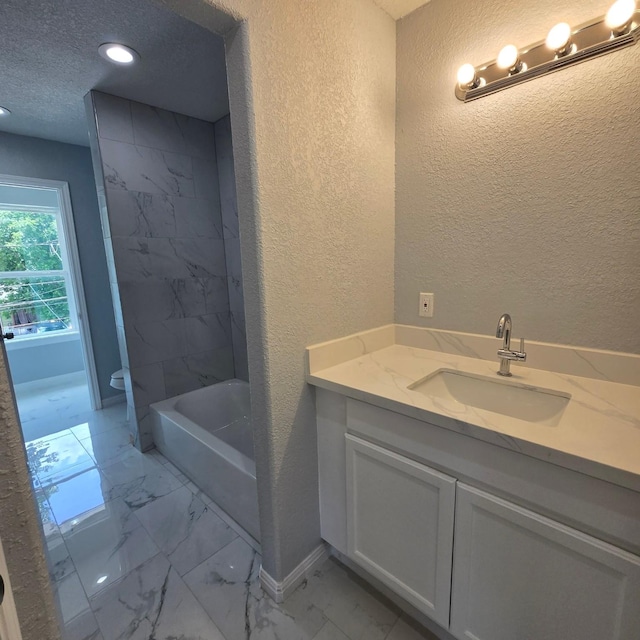 6232 Nuben St, Houston, TX 77091 - bathroom featuring a textured wall, marble look tile flooring, vanity, recessed lighting, and  shower combination