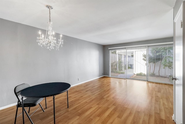 dining area featuring a notable chandelier and light wood-type flooring