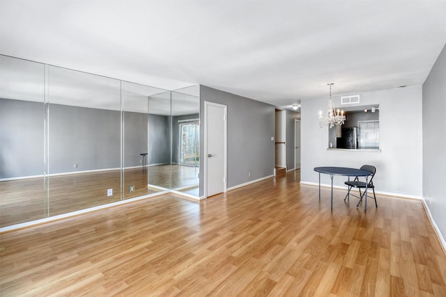 interior space featuring a notable chandelier and light hardwood / wood-style flooring