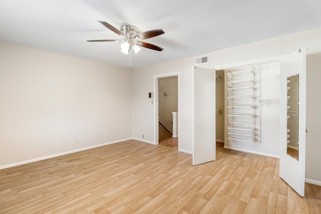 unfurnished bedroom with a closet, light hardwood / wood-style flooring, and ceiling fan