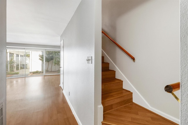 staircase featuring hardwood / wood-style floors