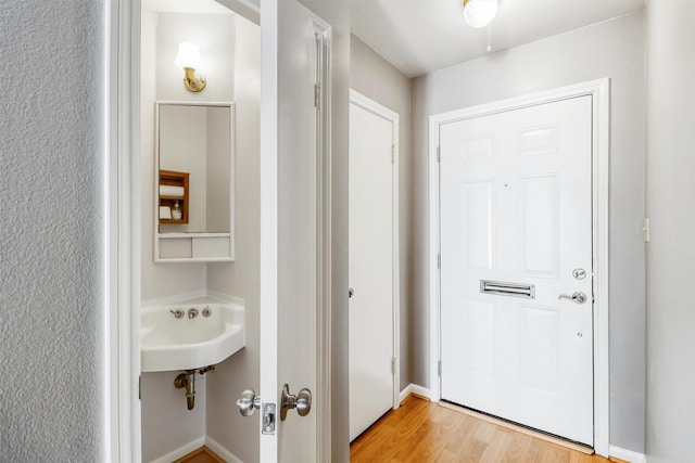 entryway featuring light hardwood / wood-style flooring and sink