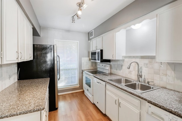 kitchen with white appliances, light hardwood / wood-style flooring, white cabinetry, and sink