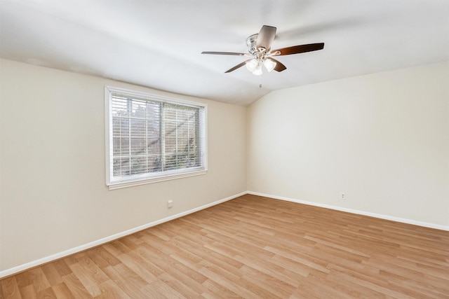 empty room featuring ceiling fan, light hardwood / wood-style floors, and lofted ceiling