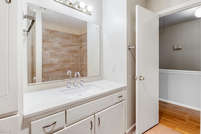 bathroom with hardwood / wood-style floors and vanity