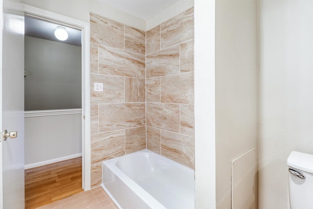 bathroom featuring hardwood / wood-style flooring and toilet