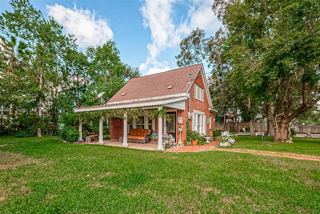 rear view of house featuring a patio and a yard